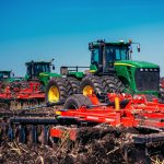 Tractor plowing farm field in preparation for spring planting